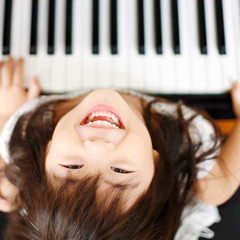 happy girl at piano